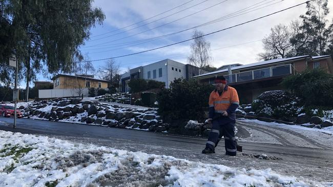 Metro workers Scott Shepard and Shane Davis were called to assist a bus that was stuck on ice at a bus stop in Trevallyn just before 9am. Picture: PATRICK GEE