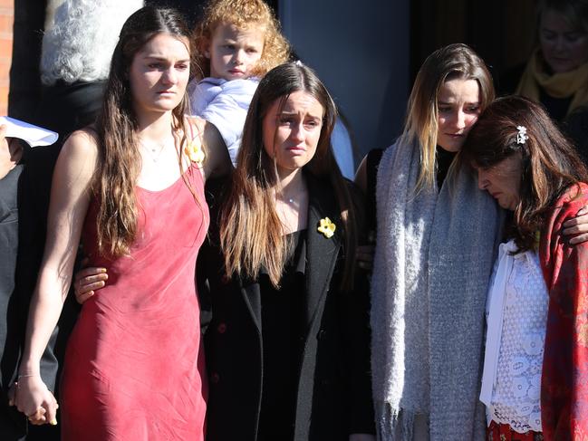 Friends of Annika Ferry Bec Bennett (in red dress) &amp; Eloise Lake (in Black) watch as the casket was moved into the car. Bec was with Annika when she died. picture John Grainger