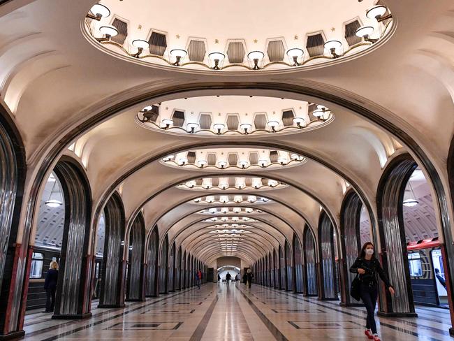 A passenger wearing a protective face mask walks on a platform at the Mayakovskaya metro station in Moscow. Picture: AFP