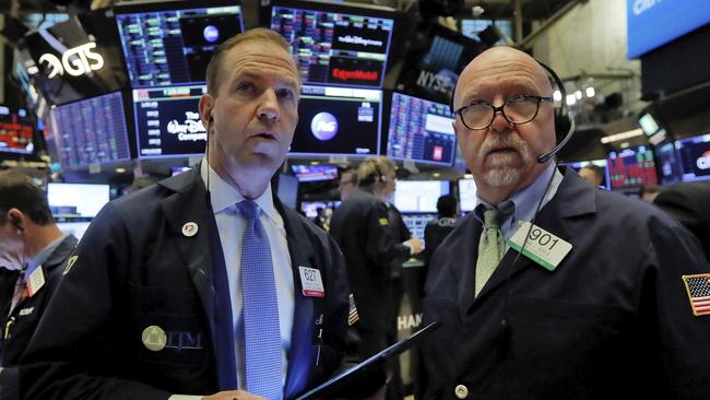 Traders Michael Smyth, left, and John Doyle on the floor of the New York Stock Exchange on Monday, looking on as stocks tumble. Picture: AP