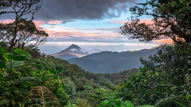 Volcan Arenal dominates the landscape during sunset, as seen from the Monteverde area, Costa Rica.