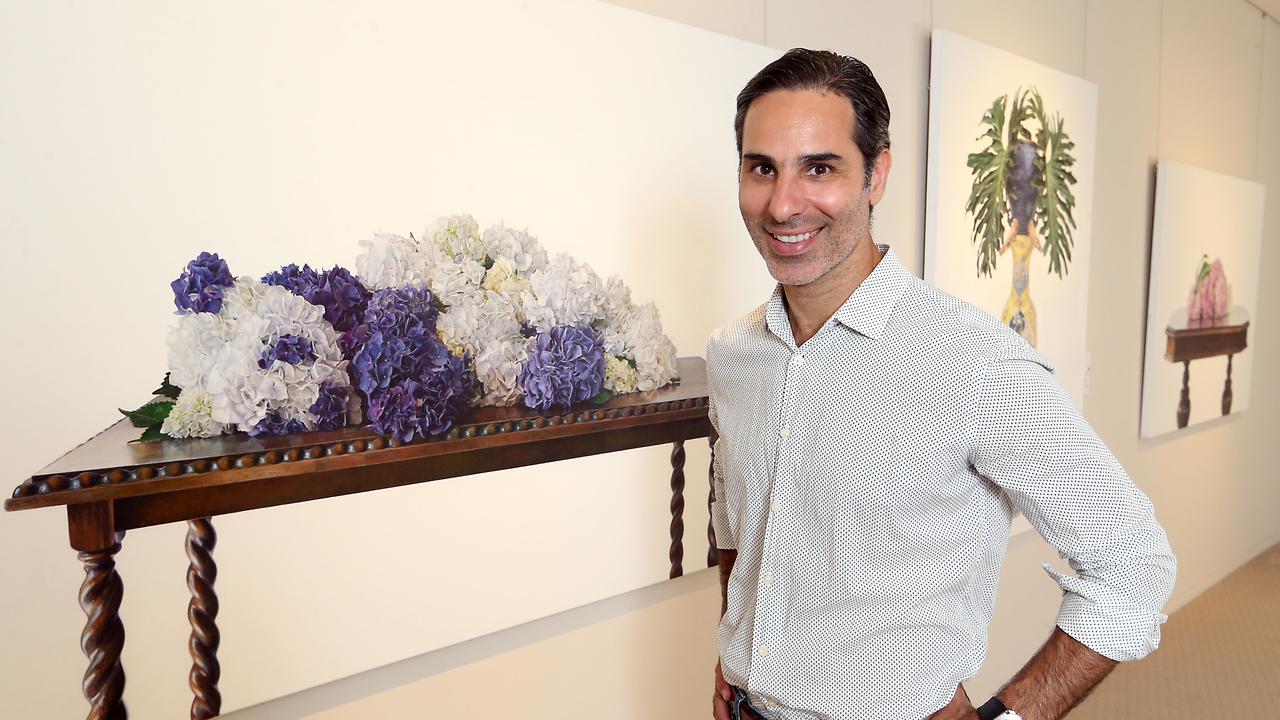 Potrait of artist Michael Zavros with some of his art work at Philip Bacon Galleries in 2019. AAP Image/Richard Gosling