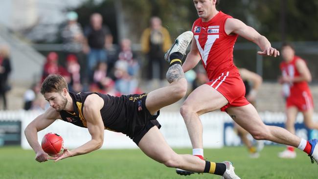 Tiger Jonty Scharenberg flicks out a handball against North Adelaide in the Round 15 clash at Prospect Oval. Picture: David Mariuz/SANFL