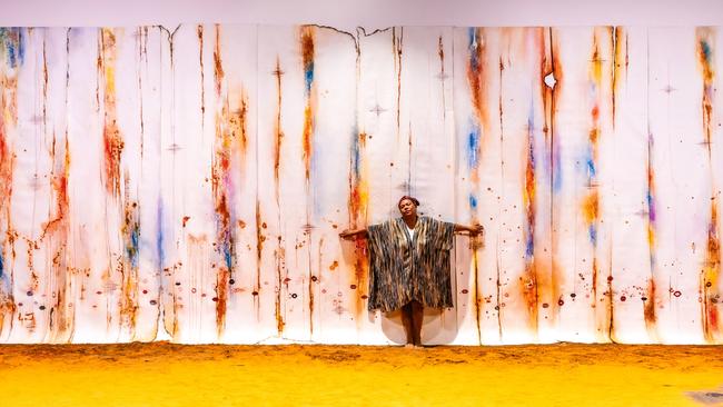 Timor-Leste artist Maria Madeira performs before her monumental work Kiss and Don’t Tell, a series of 25 three-metre panels, at the Venice Biennale. Picture: courtesy Maria Madeira and Anna Schwartz gallery, Cristiano Corte