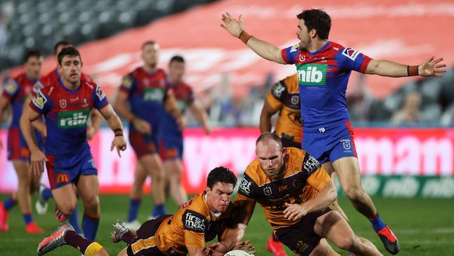 GOSFORD, AUSTRALIA - JUNE 18: Brodie Croft of the Broncos and Matthew Lodge of the Broncos dive on the ball during the round six NRL match between the Newcastle Knights and the Brisbane Broncos at Central Coast Stadium on June 18, 2020 in Gosford, Australia. (Photo by Cameron Spencer/Getty Images)