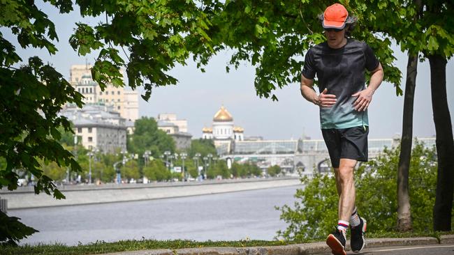 A jogger runs alongside the Moskva river in front of the Christ the Saviour cathedral in Moscow. Picture: AFP