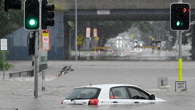 Car in the flooded water in Widdop st, Nundah. Picture: NCA NewsWIRE / John Gass