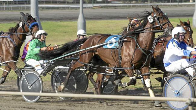 KEEPING PACE: Lola Weidemann (green) driving at Clifford Park.  She will drive a pacer in each heat tomorrow at the Warwick Show. Picture: Nev Madsen