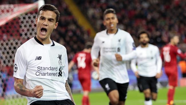 Liverpool's Philippe Coutinho, left, celebrates after scoring