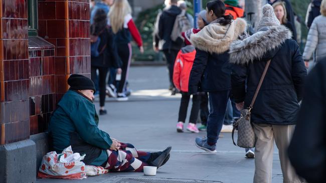 Begging on one of Melbourne’s busiest corners, opposite Flinders St station. Picture: Jason Edwards