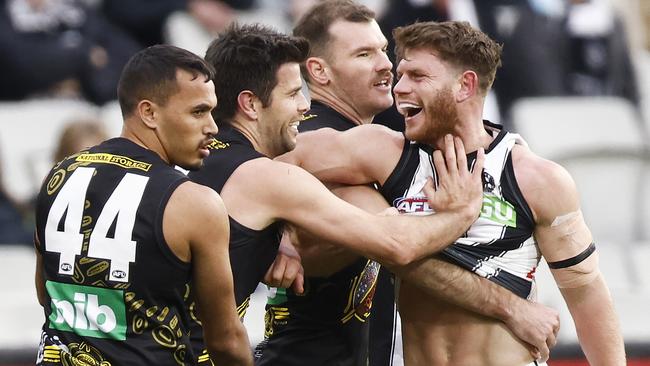 Richmond skipper Trent Cotchin fends off Collingwood’s Taylor Adams in the Tigers’ disappointing loss.