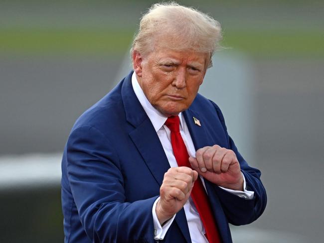 TOPSHOT - Former US President and Republican presidential candidate Donald Trump gestures during a campaign rally at the North Carolina Aviation Museum & Hall of Fame in Asheboro, North Carolina, August 21, 2024. (Photo by Peter Zay / AFP)