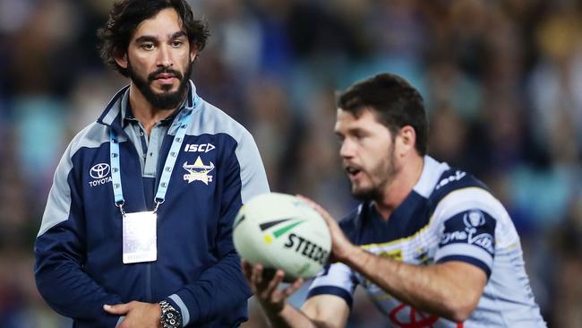 Johnathan Thurston looks on as Lachlan Coote and the Cowboys warm up.