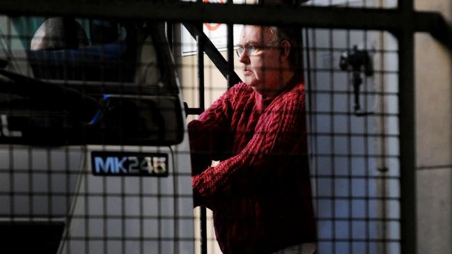 Catholic priest John Sidney Denham is led out of Central Local Court in Sydney in 2008. Picture: AAP