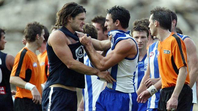 Firrito wrestles with Brendan Fevola.