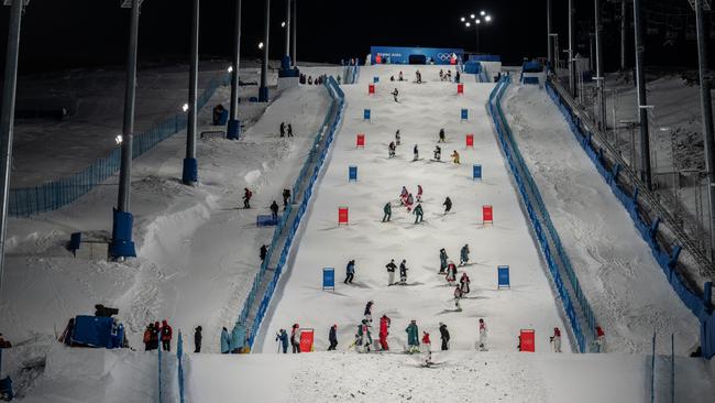 Team members check the course before a freestyle skiing moguls practice session at Genting Snow Park (Photo by Carl Court/Getty Images).