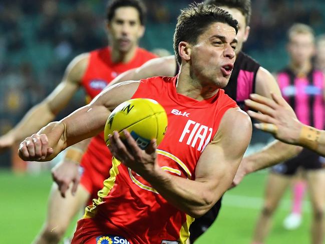 LAUNCESTON, AUSTRALIA - JUNE 26: Dion Prestia of the Suns handballs whilst being tackled by Jordan Lewis of the Hawks during the round 14 AFL match between the Hawthorn Hawks and the Gold Coast Suns at Aurora Stadium on June 26, 2016 in Launceston, Australia. (Photo by Quinn Rooney/Getty Images)