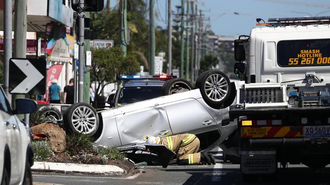 Emergency service at the scene of a single-car rollover on the Gold Coast Highway. Photograph : Jason O'Brien