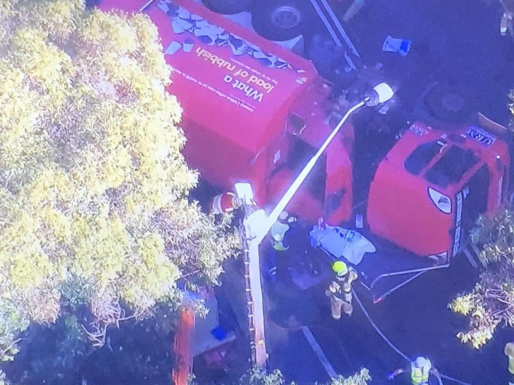 Emergency services are working to free a man from the site of the truck rollover. Picture credit: 2GB Radio