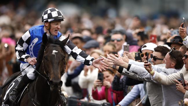 Mark Zahra riding #1 Gold Trip celebrates with spectators after winning the Melbourne Cup