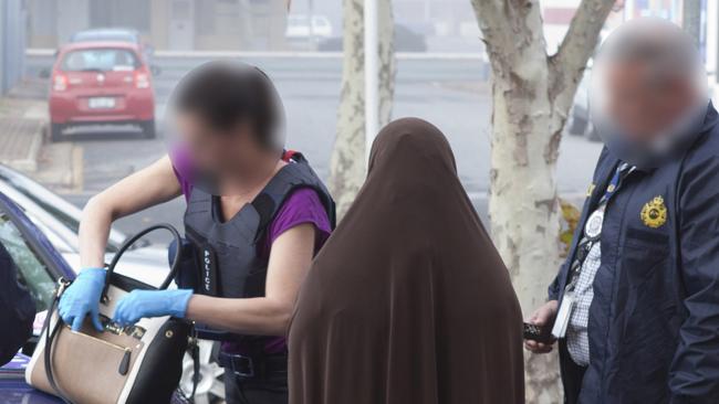 Australian Federal Police officers during the arrest of Zainab Abdirahman-Khalif.