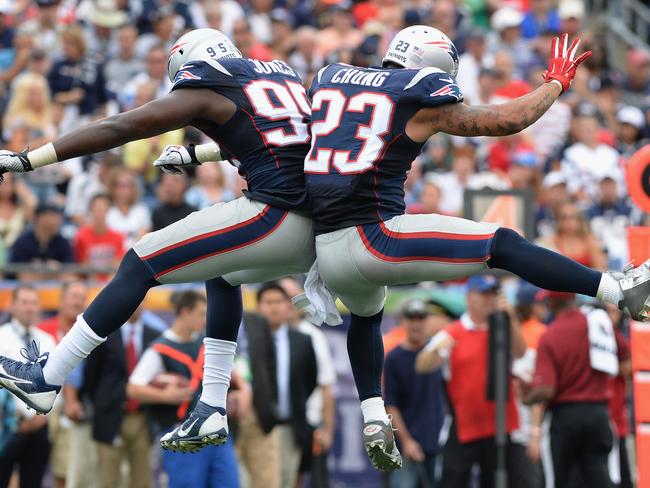 Chandler Jones #95 and Patrick Chung #23 of the New England Patriots celebrate during the fourth quarter against the Oakland Raiders.