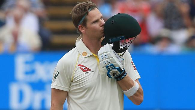 Australia’s Steve Smith kisses the badge on his helmet as he celebrates his second century in the first Ashes Test at Edgbaston. Picture: AFP