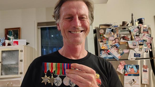 Paul Stuart with replica medals earned by his grandfather Charlie Wilson in World War II.