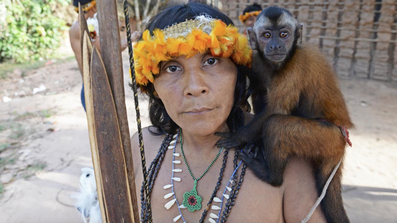 An Awa woman with her hunting bow, arrows and pet monkey in Brazil. Picture: Scott Wallace/Getty Images
