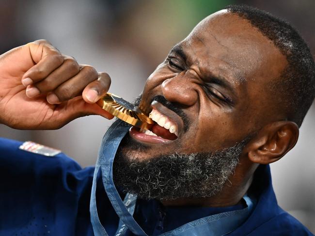 TOPSHOT - Gold medallist USA's #06 LeBron James poses on the podium after the men's Gold Medal basketball match between France and USA during the Paris 2024 Olympic Games at the Bercy  Arena in Paris on August 10, 2024. (Photo by Aris MESSINIS / AFP)