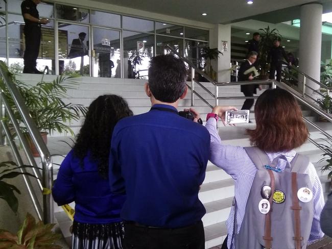 Journalists stand outside the entrance of the Shah Alam court house at the trial of two women accused of killing Kim Jong-nam. Picture: AP