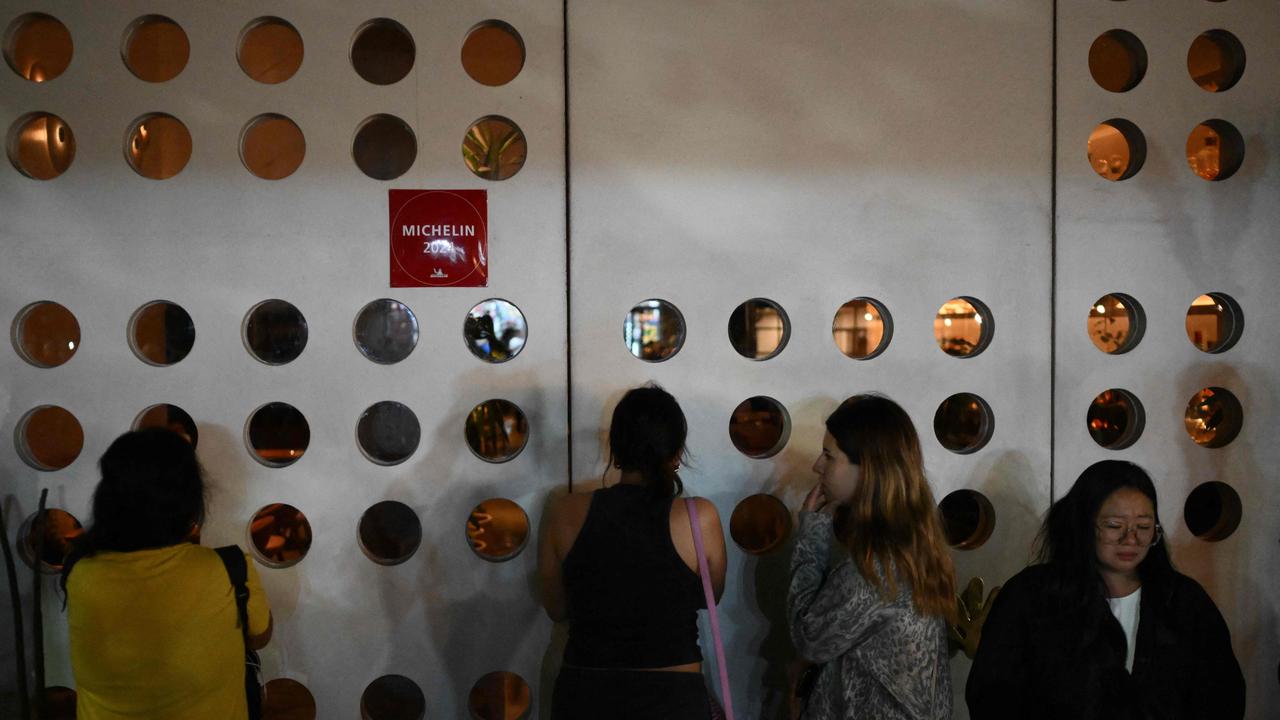 Fans outside were seen looking through the hotel windows. Picture: Luis Robayo/AFP