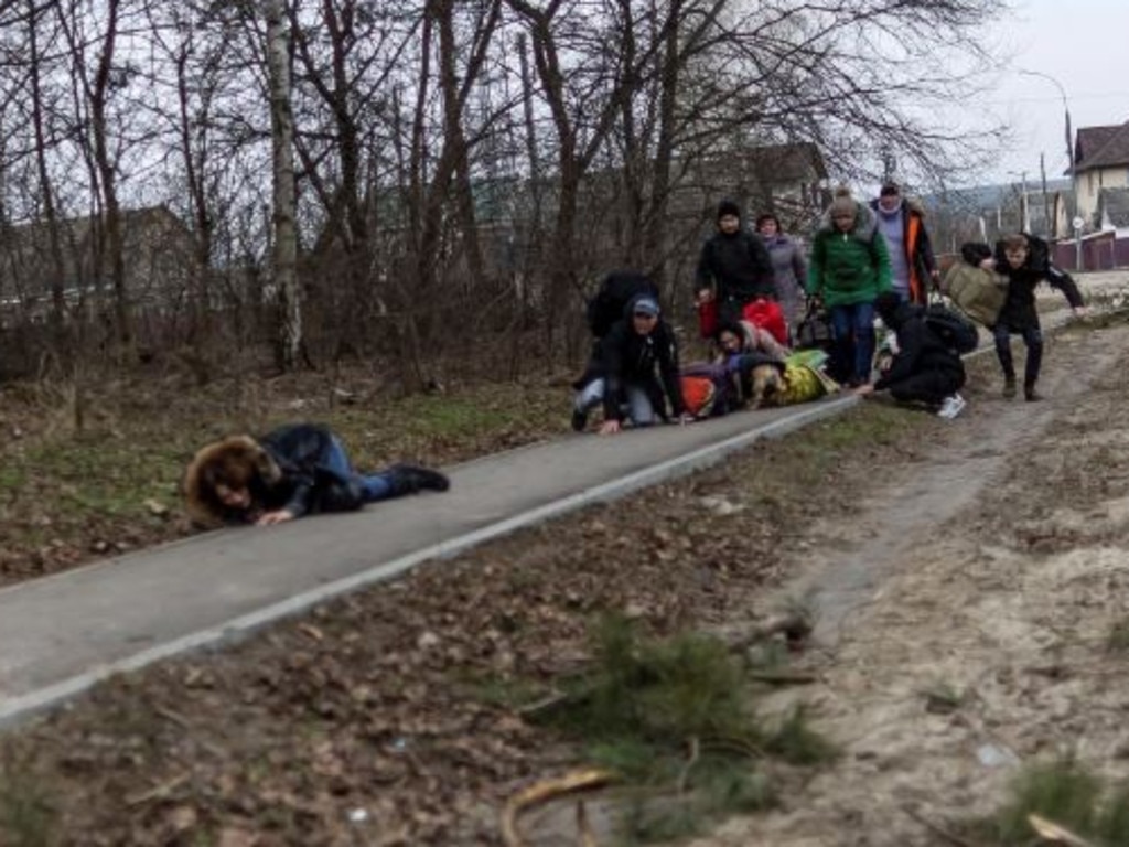 Civilians duck for cover as shells rain down across the city just 25 kilometres from Kyiv. Picture: Reuters