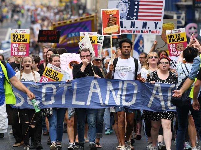 People march holding anti-Trump signs on the streets of Glasgow. Picture: Getty Images