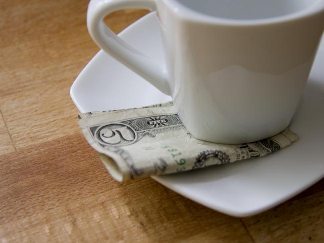 ESCAPE: TIPPING IN AMERICA  ..  cash tip on a restaurant table. Picture: iStock