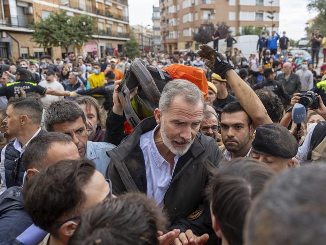 Spain's King Felipe VI speaks with people amid angry Spanish flood survivors in Paiporta. Picture: AP