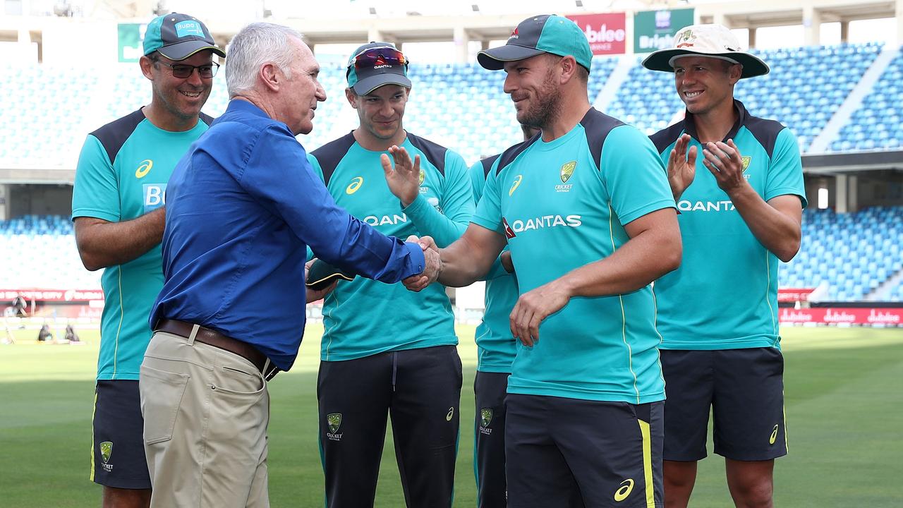 Aaron Finch receives his Baggy Green cap from Allan Border during day one of the First Test match in the series between Australia and Pakistan at Dubai International Stadium on October 7, 2018. (Photo by Ryan Pierse/Getty Images)