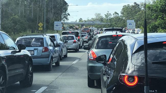 Paramedics, police, and fire trucks are at the scene of a truck rollover in Gaven. Picture: Supplied