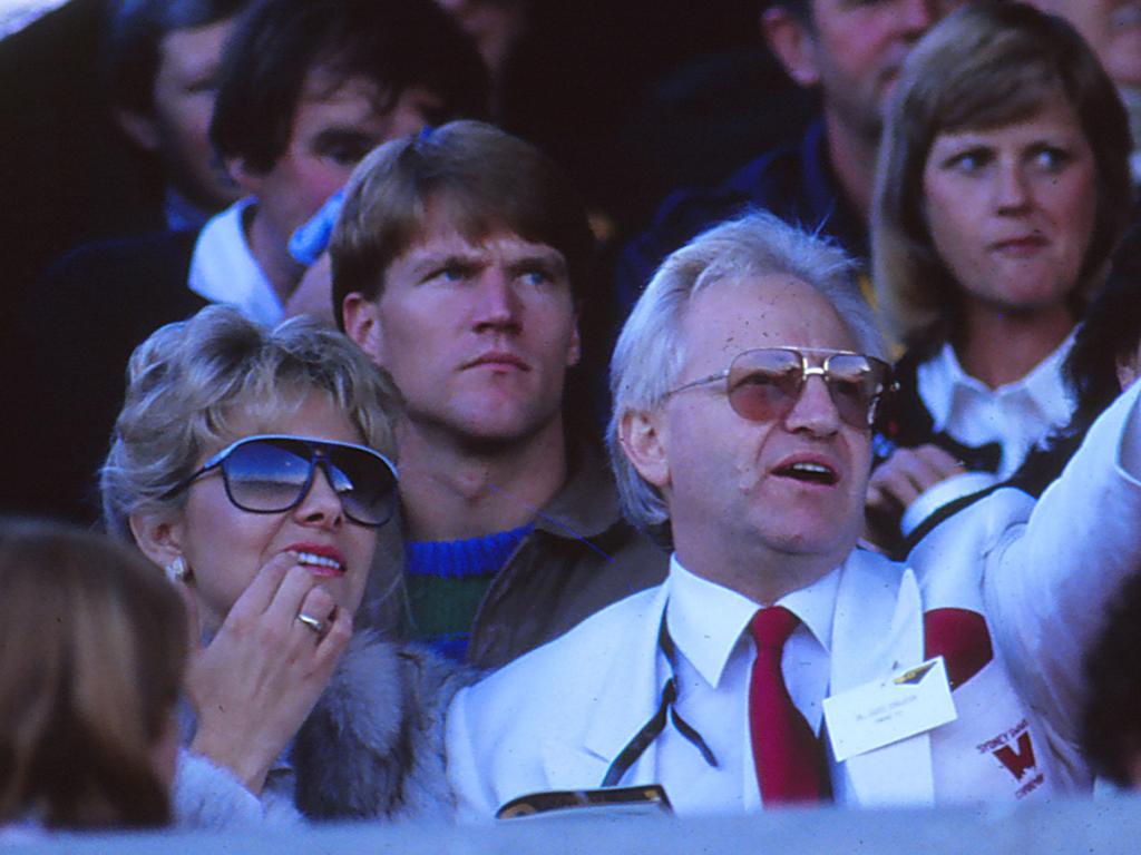 Geoffrey Edelsten watches on from the stands.