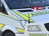 Emergency crews treating motorbike rider after forest crash