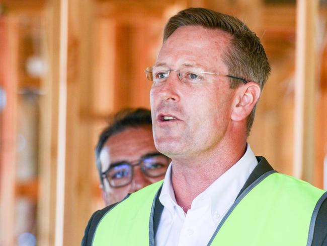 Premier Steven Marshall behind Mineral Resources and Energy minister Dan van Holst Pellekaan at a new solar batteries announcement at an Atholstone home under construction, Wednesday, January 29, 2020. (Photo: AAP/Brenton Edwards)