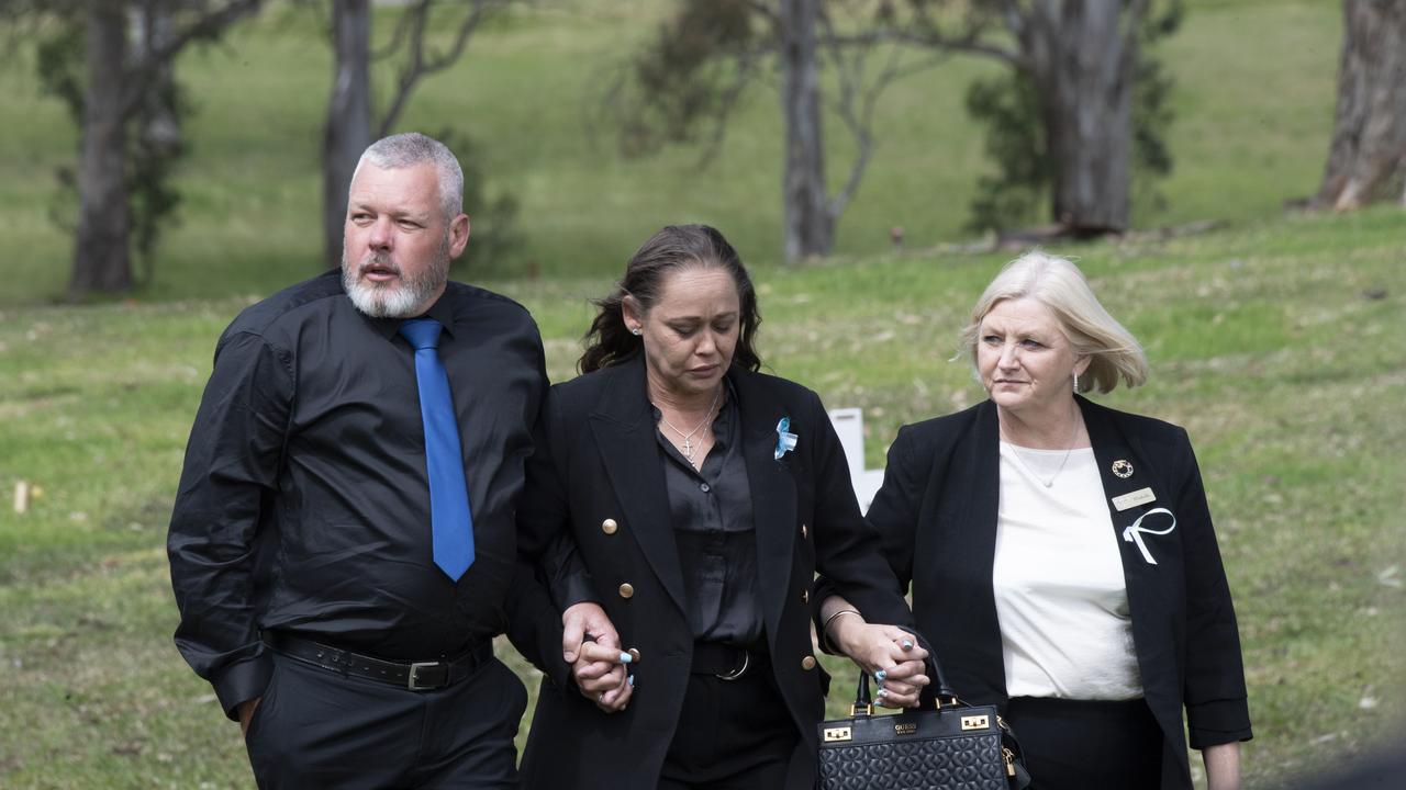 Family members hold hands as they leave the service. Picture: NCA NewsWire / Monique Harmer