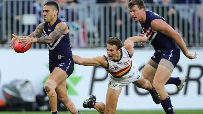 Tom Doedee latches on to Michael Walters to win a holding-the-ball decision in one of few highlights for the Crows in the second half at Perth’s Optus Stadium on Sunday. Picture: Paul Kane/Getty Images