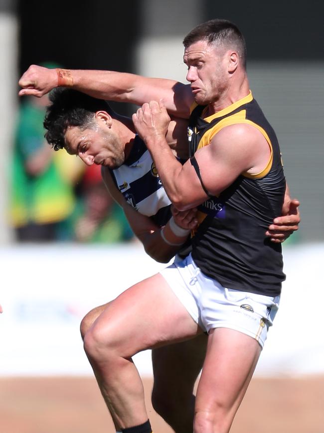 Yarrawonga captain Leigh Masters and Albury’s Brayden O’Hara go hard at the ball.