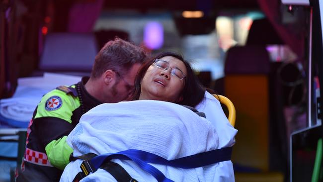 Paramedics tend to an injured woman from the Hotel CBD. Picture: AAP