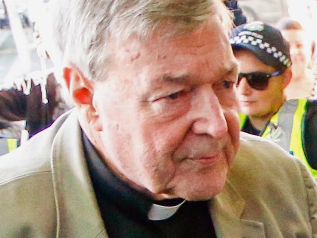 FILE - In this March 5, 2018, file photo, Cardinal George Pell arrives for a hearing at an Australian court in Melbourne, Australia. A lawyer for the most senior Vatican official ever charged in the Catholic Church sex abuse crisis told the Australian court on Tuesday, April 17, 2018 that Pell could have been targeted with false accusations to punish him for the crimes of other clerics. (AP Photo/Asanka Brendon Ratnayake, File)