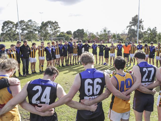 Local footballers from Melbourne University Blacks and St Bernards pay their respects at the scene. Picture: Wayne Taylor