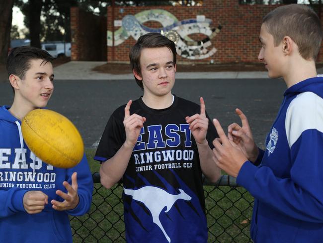 June 5 ,Max Beasley, 14 ( kangaroo logo on shirt ), is the only deaf junior footballer in the EFL. His Ringwood East FC team mates have been learning sign language . Satchi Halit, Max Beasley, and Joel Tanzen.Picture: Stuart Milligan