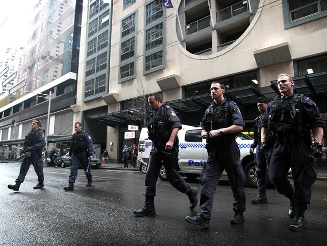 Strike Force Raptor officers after a raid on the unit owned by Felix Lyle on Pitt St in Sydney's CBD in 2011.