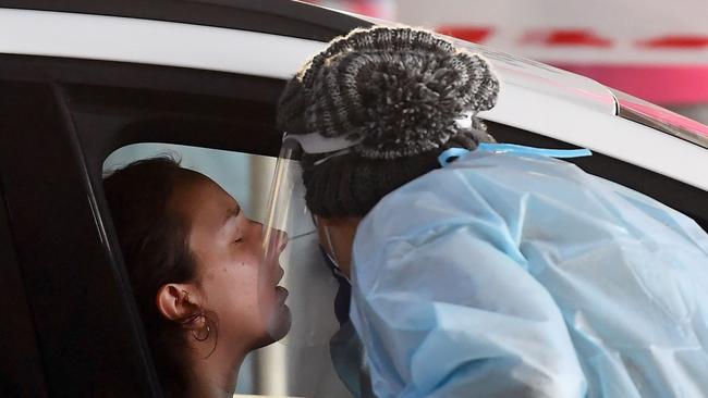 Medical workers staff a drive-through COVID-19 testing site located in a shopping centre carpark in Melbourne. Picture: William West/AFP